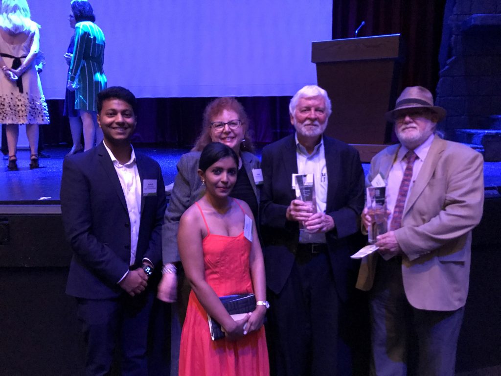 Group with Girard at front of stage